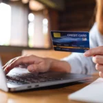 Where Are Capitation Payments Entered in Medisoft? - A woman holding credit cards while using laptop computer for online payment