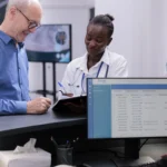 African american doctor showing medical expertise to elderly patient discussing medication treatment - Medisoft Running Slow? Here’s How to Fix It Fast - Computer Mate - Medical Software