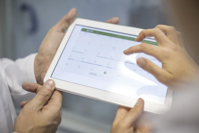 Two scientist sharing tablet - What Is the Purpose of Color-Coded Transactions in Medisoft - Computer Mate Medisoft Software Medical Billing 